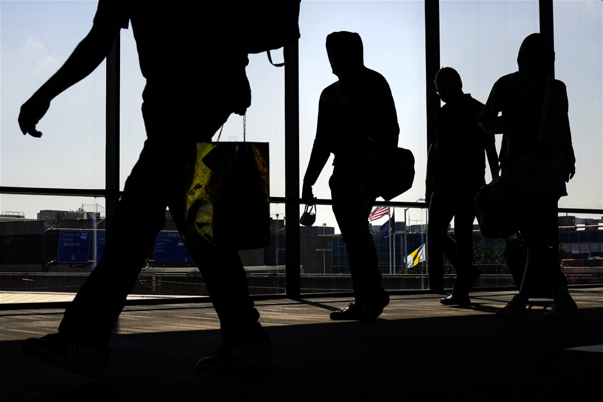 <i>Matt Rourke/AP</i><br/>Arriving passengers move toward the baggage claim area at Philadelphia International Airport in Philadelphia in July.