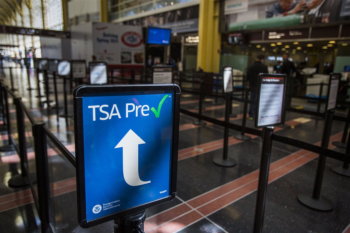 <i>Jim Lo Scalzo/EPA/Shutterstock</i><br/>The price for TSA PreCheck has dropped. A sign directs travelers enrolled in the TSA pre-check system to a short security line at Reagan National Airport in Arlington