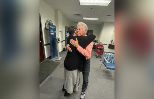 Highsmith hugs her father while being reunited after decades of separation.