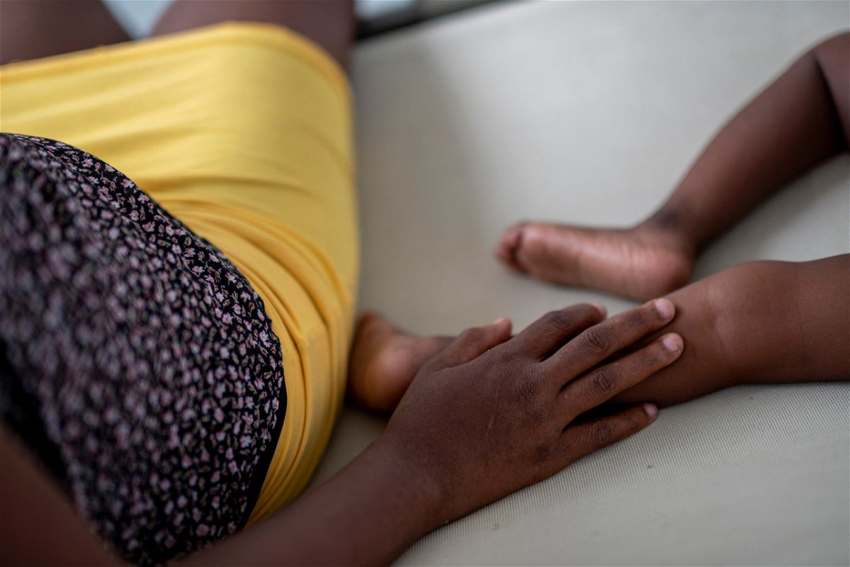 <i>Ricardo Arduengo/Reuters</i><br/>A woman sits next to a child as he receives treatment for cholera at the Gheskio Center Hospital supported by UNICEF in Port-au-Prince