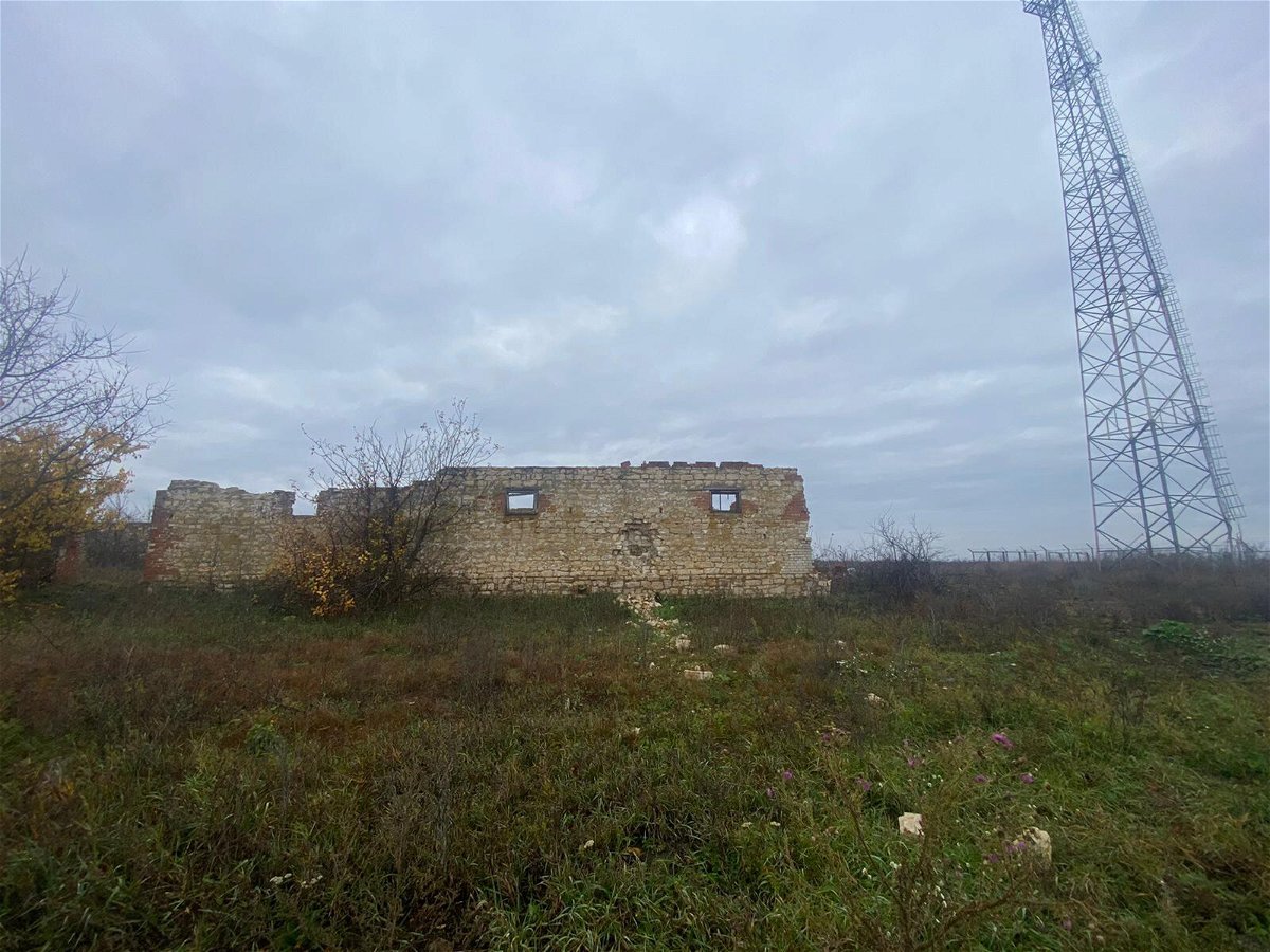 <i>Nic Robertson/CNN</i><br/>The mangled cellphone tower behind the basement bunker where Ukrainian soldiers likely died would have been an excellent marker for enemy artillery.