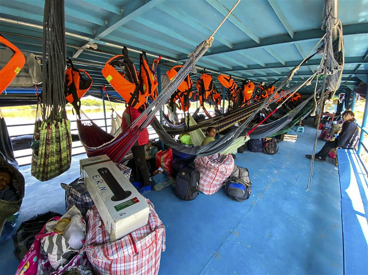<i>Angela Ramirez/AFP/Getty Images</i><br/>Foreign and Peruvian tourists wait in the boat where they have been detained at the Cuninico community in Loreto in the north of Peru