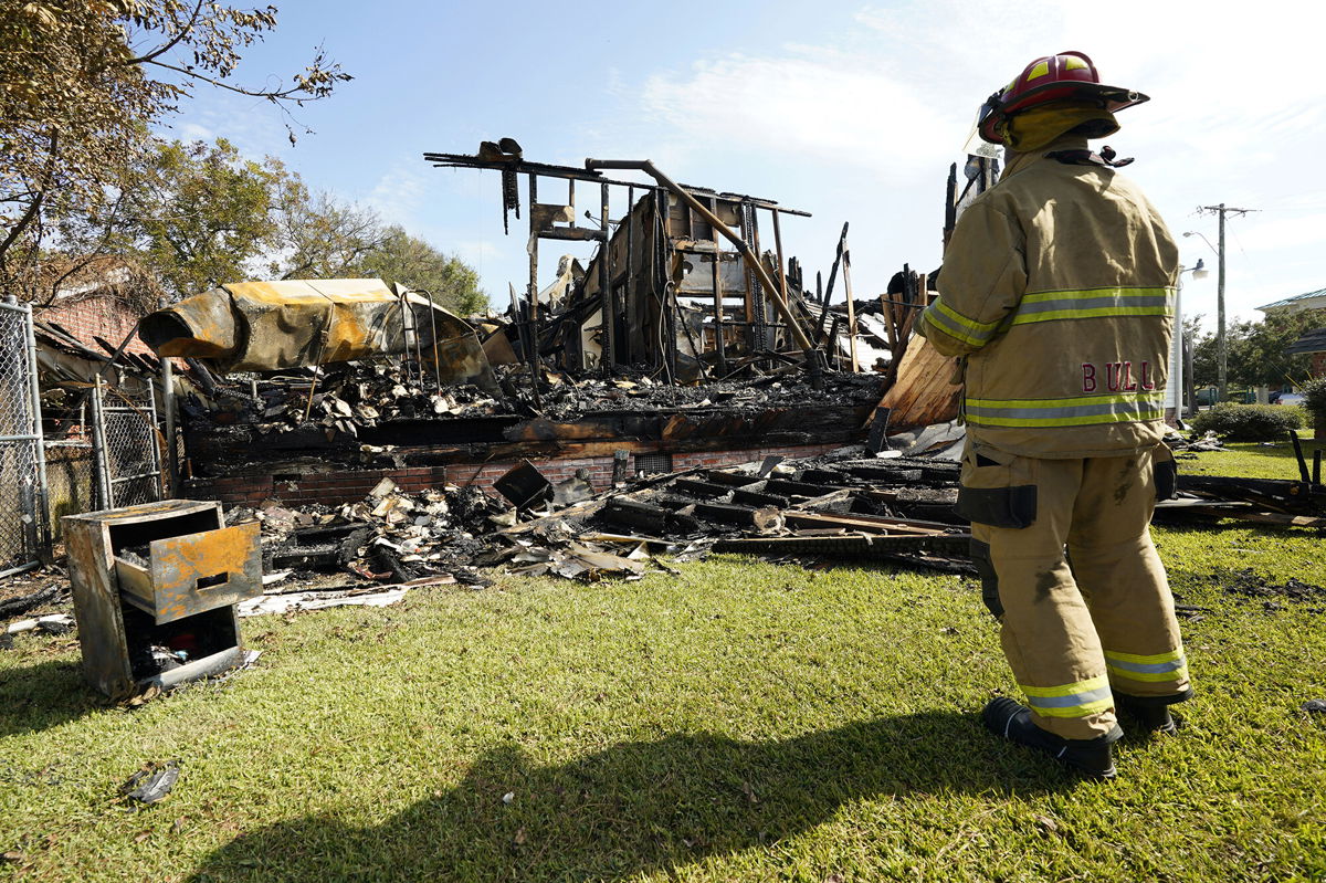<i>Rogelio V. Solis/AP</i><br/>A fireman observes the remains of a burned Epiphany Lutheran Church near midtown Jackson