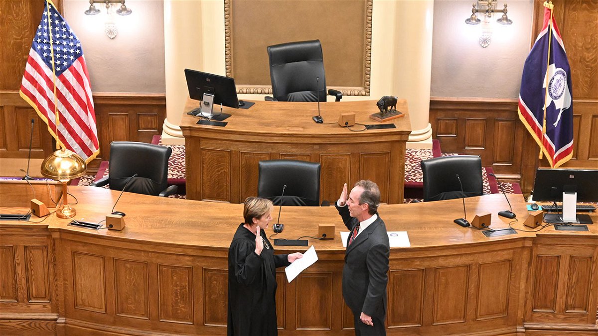 Wyoming Supreme Court Justice Kari Jo Gray administers the oath of office to Bob Ide in the Senate Chamber of the Wyoming State Capitol in Cheyenne Tuesday.