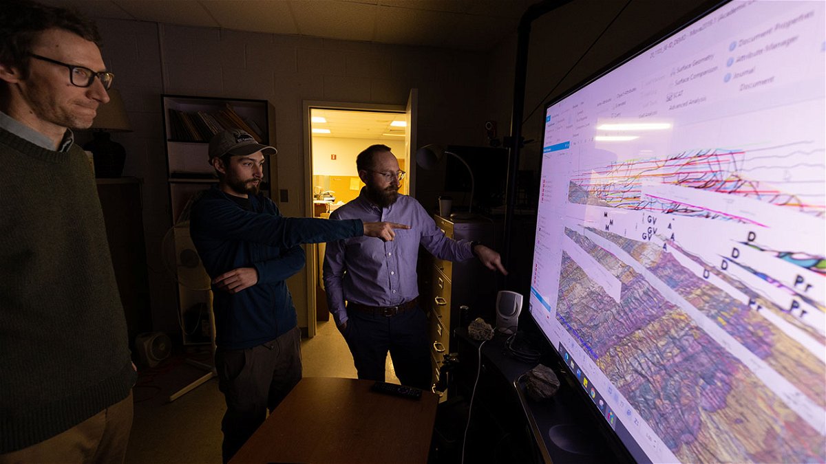 Dave Pearson, associate professor of geosciences, left, Matthew Ruggiero, master’s student, center, and Ryan Anderson, assistant professor of geosciences, talk about fault lines that are displayed on screen running MOVE suite donated to ISU from Petex on Thursday, December 08, 2022.