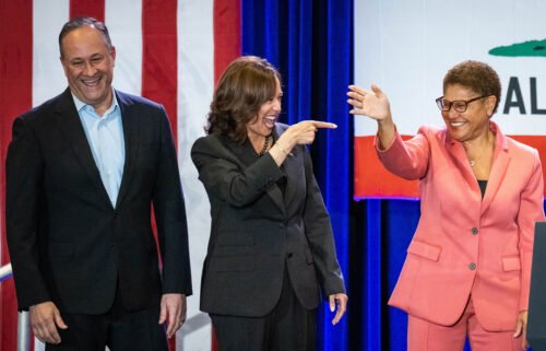 Vice President Kamala Harris (middle) and second gentleman Doug Emhoff (left) join Karen Bass as she campaigns at UCLA in Los Angeles on November 7.