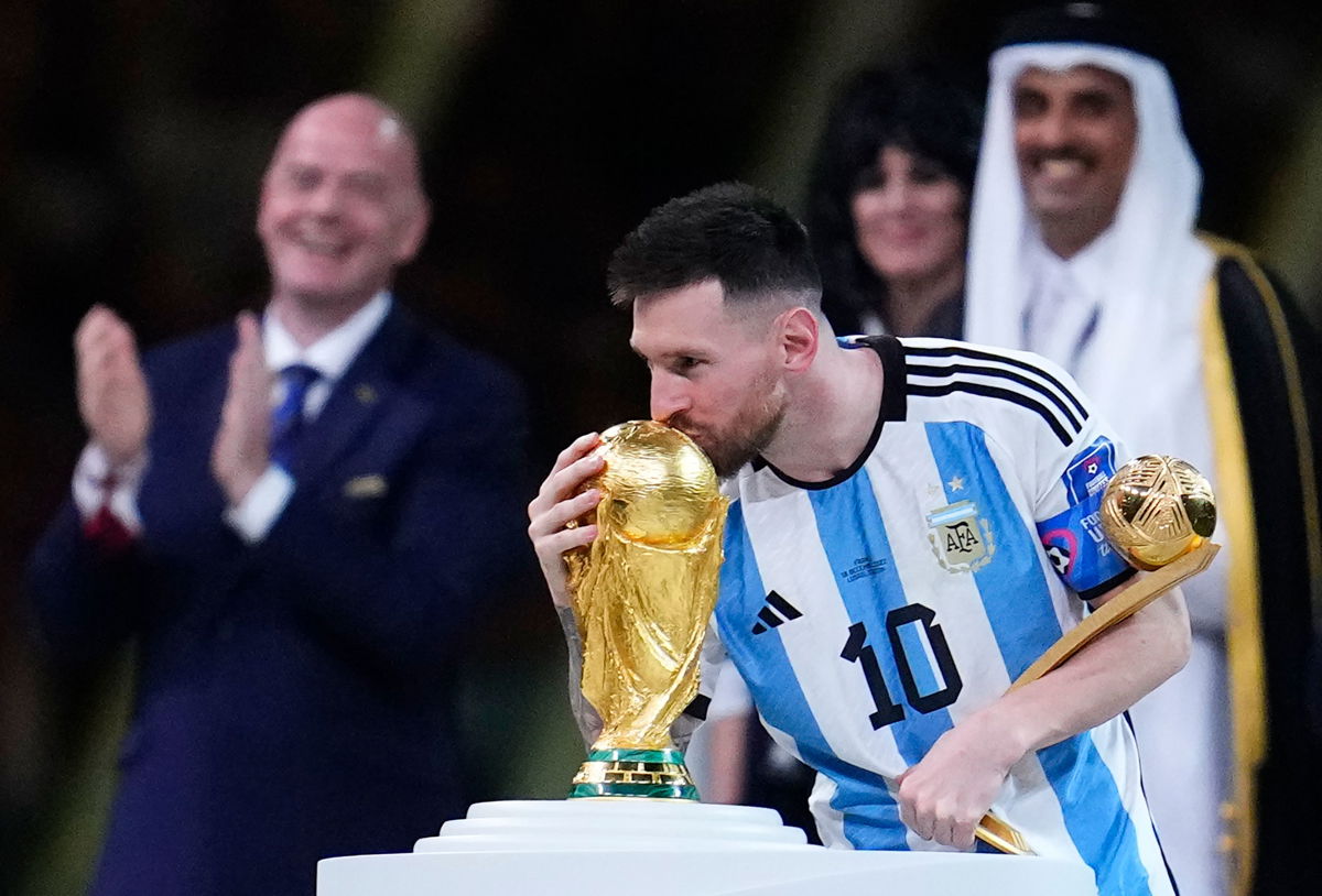 <i>Natacha Pisarenko/AP</i><br/>Lionel Messi kisses the World Cup trophy after receiving the Golden Ball award for best player of the tournament.