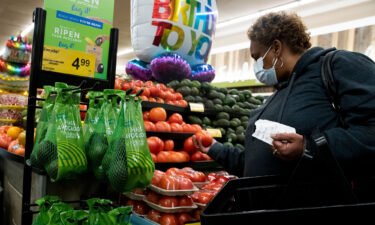 Inflation is at its lowest level in almost a year. A person shops at a grocery store in Washington