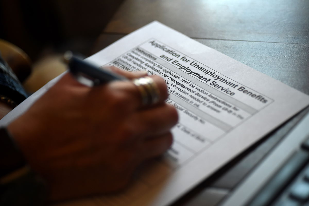 <i>Olivier Douliery/AFP/Getty Images</i><br/>A person files an application for unemployment benefits on April 16