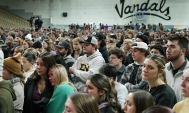 People attend a November 30 vigil for the four University of Idaho students stand in the Kibbie Dome as family members talk about their loved ones in Moscow