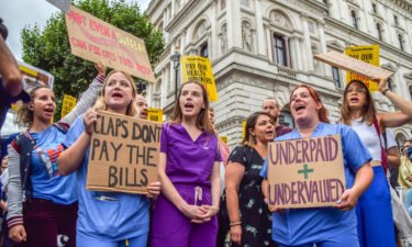 Protesters hold placards demanding fair pay for healthcare workers during a demonstration outside Downing Street.