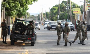 Members of security forces guard the streets after Jamaican Prime Minister Andrew Holness declared a state of public emergency in parts of the capital Kingston
