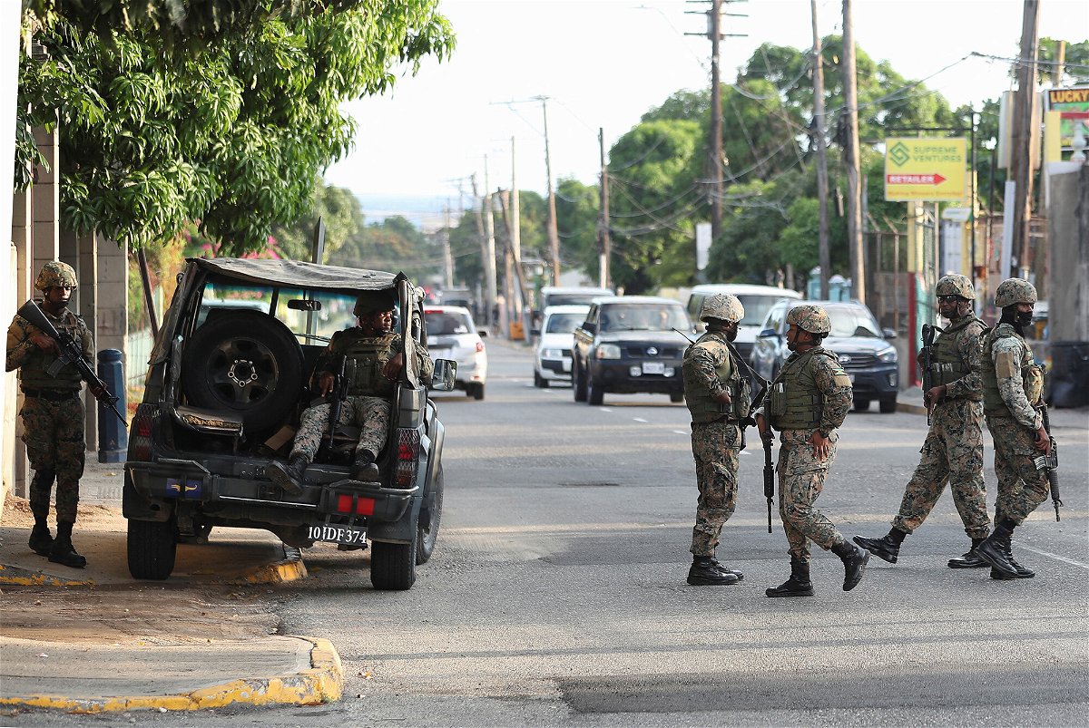 <i>Gilbert Bellamy/Reuters</i><br/>Members of security forces guard the streets after Jamaican Prime Minister Andrew Holness declared a state of public emergency in parts of the capital Kingston