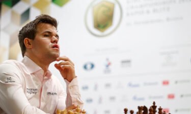 Magnus Carlsen of Norway sits in front of a chess board before a game.