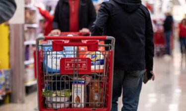 Consumers are feeling slightly better about the direction of the economy. A customer pushes a shopping cart at a Target store on Black Friday in Chicago