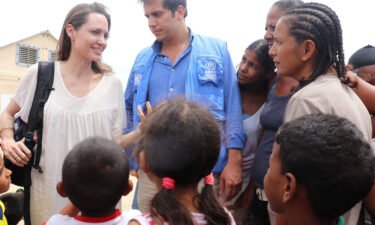 Special envoy Angelina Jolie talks to people inside a camp run by the UN Refugee Agency