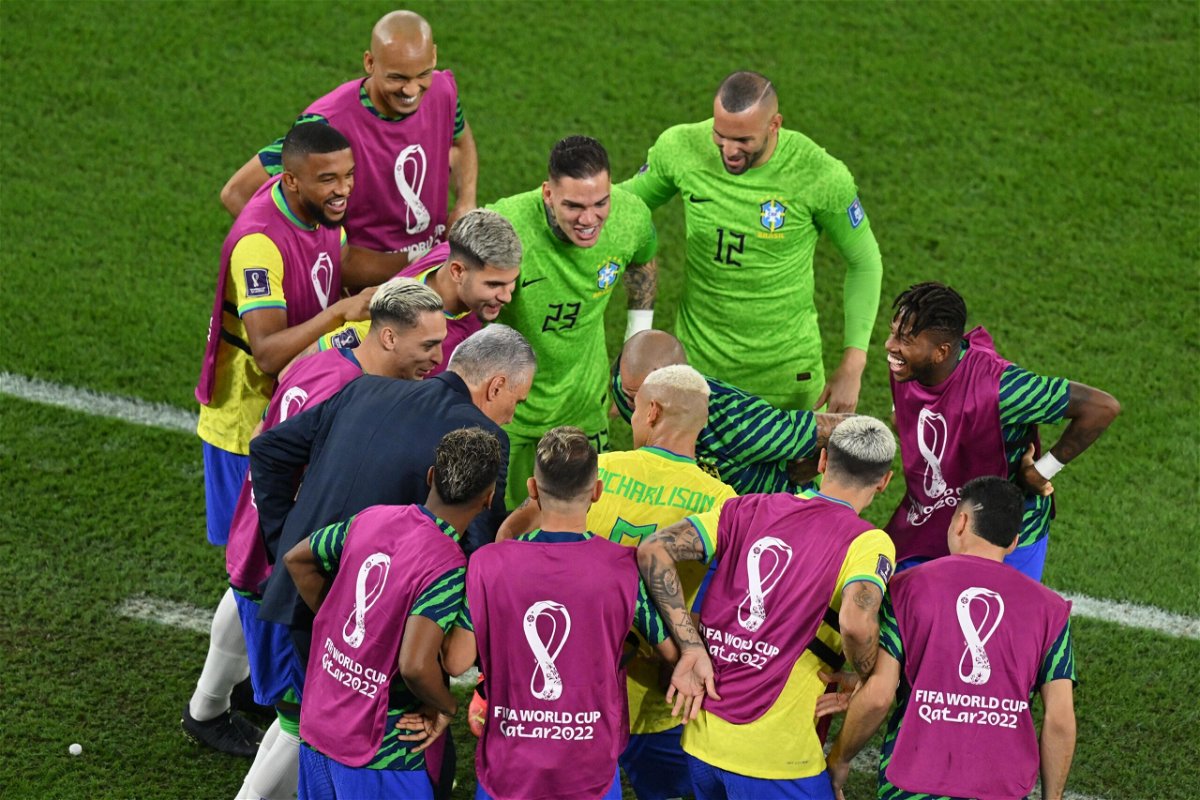 <i>GLYN KIRK/AFP/AFP via Getty Images</i><br/>Tite joined in with Brazil's celebrations for the third goal.