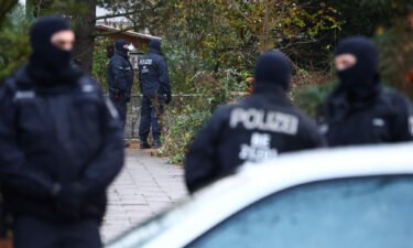 Police secure an area in Berlin after 25 suspected members and supporters of a far-right group were detained during raids across Germany on Wednesday.