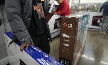 Shoppers claim the few televisions on display during early Black Friday shopping at Walmart Supercenter in Alexandria