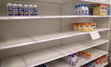 Similac and Enfamil products are seen on largely empty shelves in the baby formula section of a Target store in San Diego on May 25.