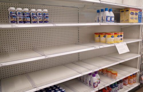 Similac and Enfamil products are seen on largely empty shelves in the baby formula section of a Target store in San Diego on May 25.