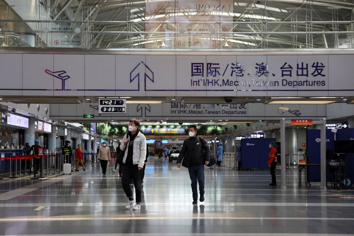 <i>Tingshu Wang/Reuters</i><br/>Travelers walk at a terminal hall of the Beijing Capital International Airport in Beijing