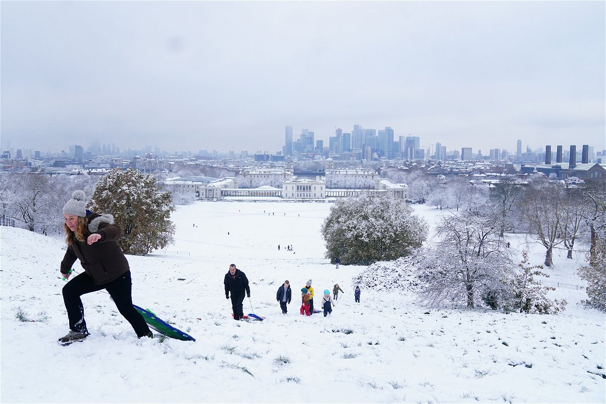<i>Victoria Jones/PA Images/Getty Images</i><br/>People sledging in the snow at Greenwich Park in London on Monday.