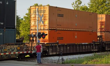 A CSX freight train runs through a crossing in Homestead
