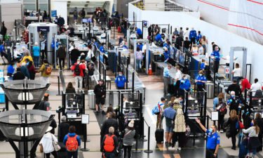The deadline for REAL ID has been extended. Airline passengers here wait at a Transportation Security Administration (TSA) checkpoint to clear security before boarding flights in Denver