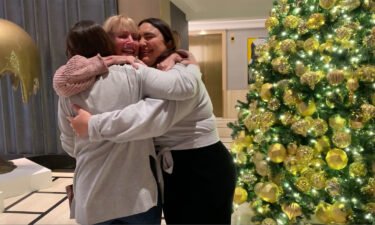 Tracy Peck and the two sisters share a hug in the lobby of their New York hotel. It was the first time they'd seen each other in person in 23 years.