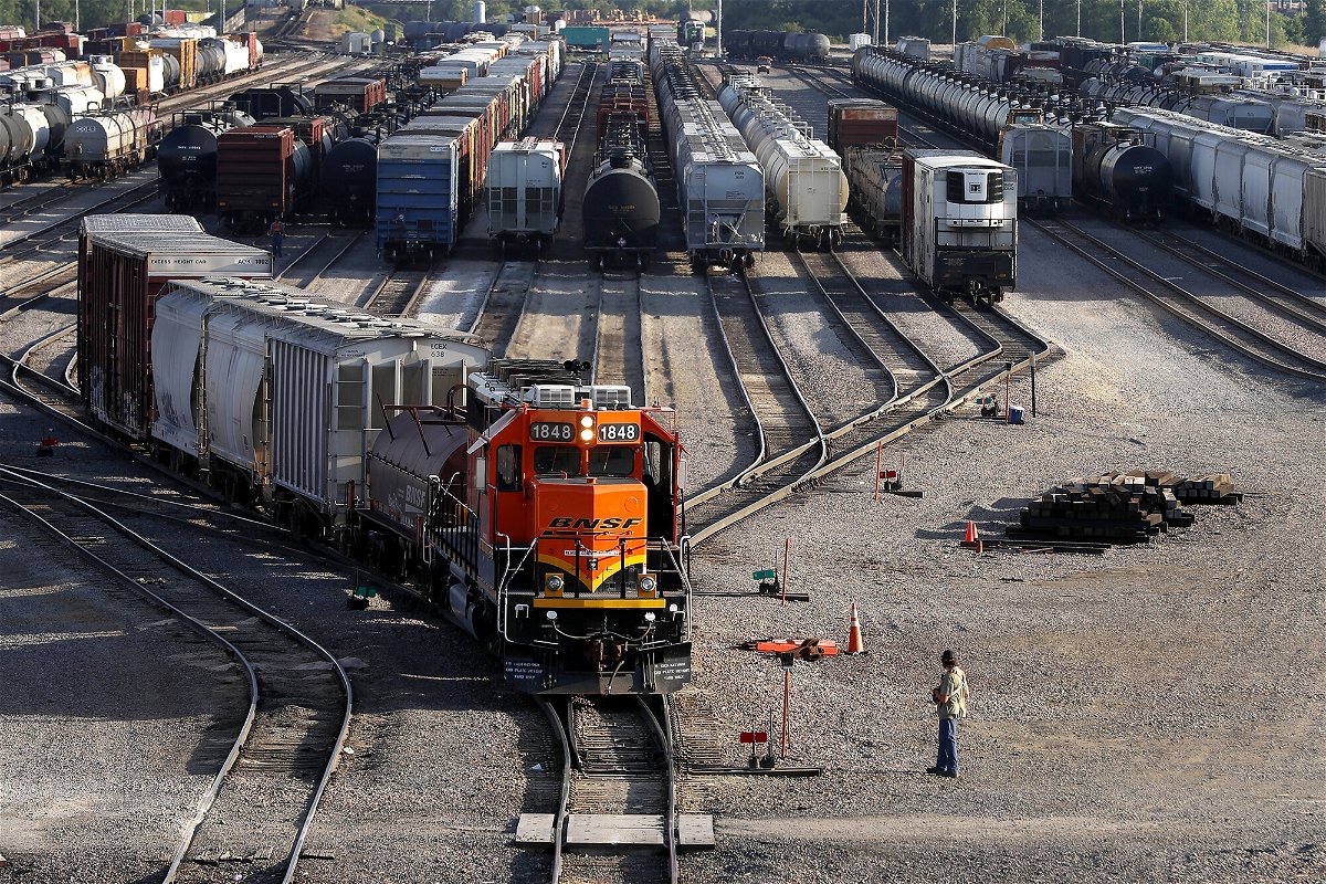 <i>Shafkat Anowar/AP</i><br/>A BNSF rail terminal worker monitors the departure of a freight train