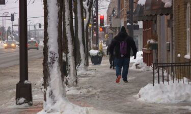 Minneapolis residents battle against - and penguin-walk across - icy surfaces.