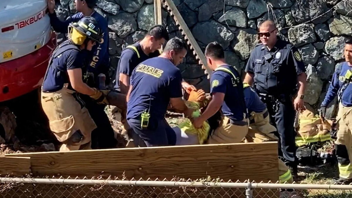 <i>KITV</i><br/>One person is dead and two others are injured after being crushed by a falling rock wall outside of a home in Kailua.