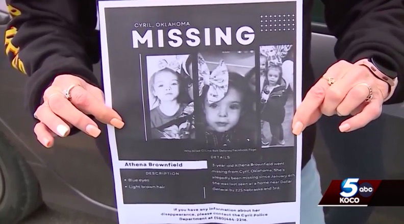 <i>KOCO</i><br/>A woman holds up the missing poster for Athena Brownfield