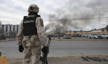 A Mexican soldiers stands guard outside a state prison in Ciudad Juarez