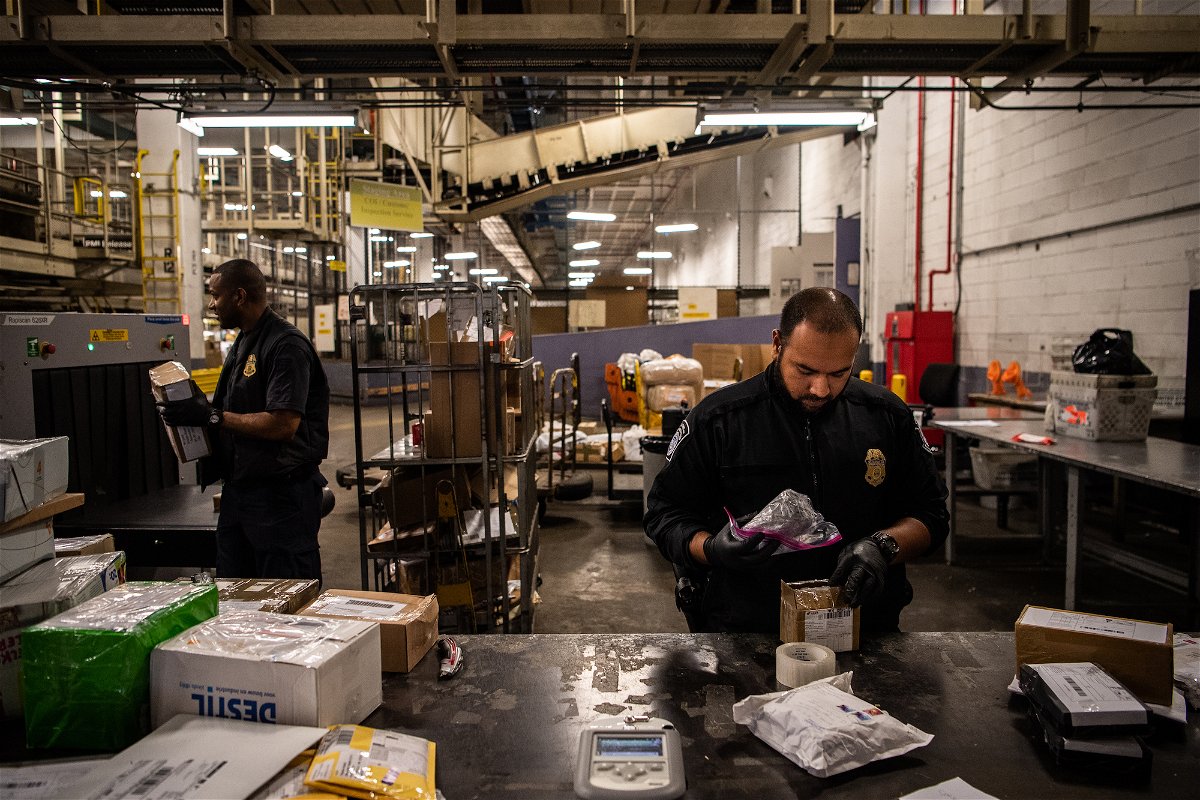 <i>Salwan Georges/The Washington Post/Getty Images/FILEE</i><br/>Customs and Border Protection Officer Mohammed Rahman holds a bag filled with white powder for testing at the JFK International Mail Facility in 2018