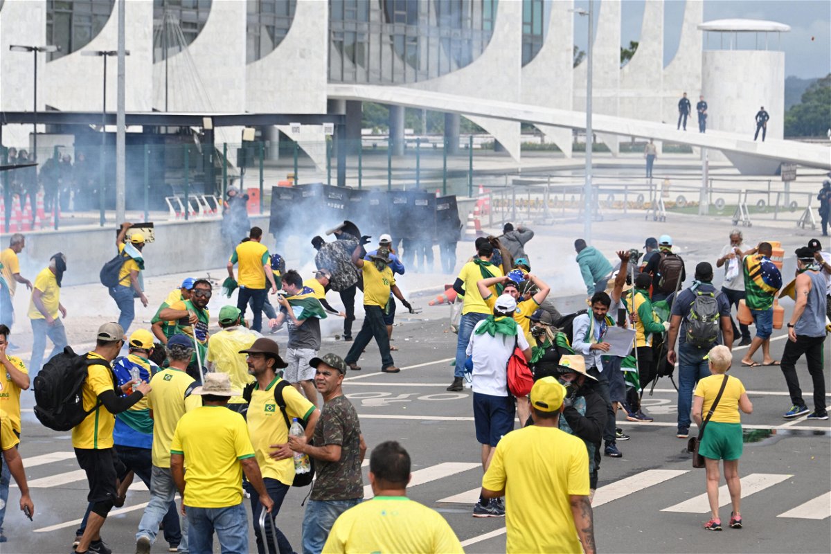 <i>Evaristo Sa/AFP/Getty Images</i><br/>Supporters of former Brazilian President Jair Bolsonaro clash with police during a demonstration outside the Planalto Palace in Brasília on Sunday.