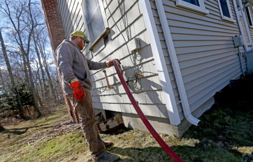 Corey Carlson of Anderson Fuel fills a house with home heating oil which has risen to over $5.00 a gallon on March 8