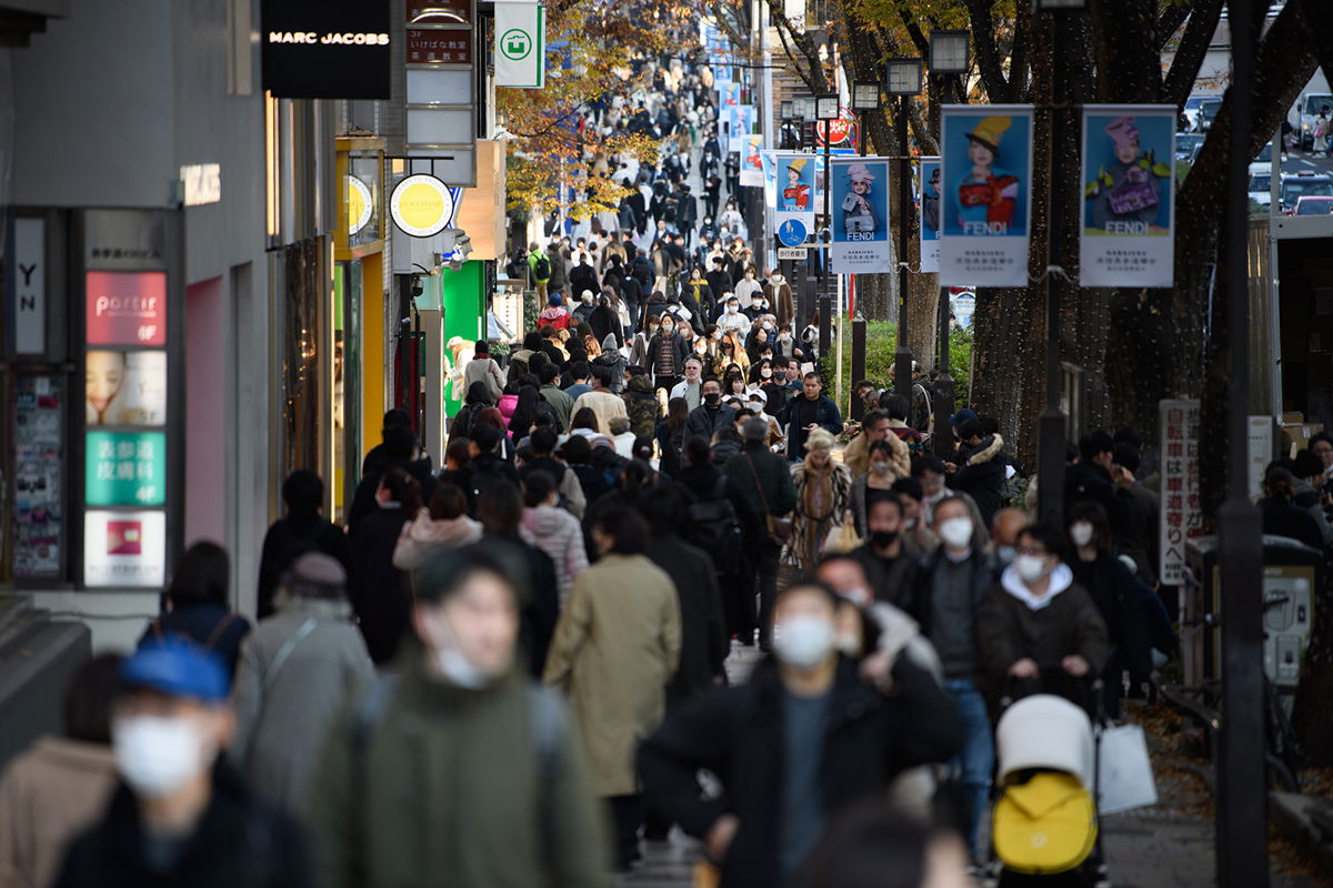<i>Akio Kon/Bloomberg/Getty Images</i><br/>Japan's leader wants businesses to hike workers' pay at a level above inflation. People here are walking walk along a street in Tokyo