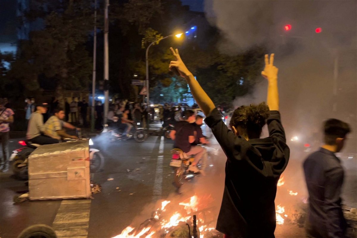 <i>AFP/Getty Images</i><br/>A demonstrator raises his arms and makes the victory sign during a protest in Tehran on September 19