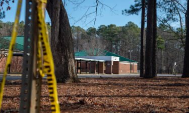 Police tape hangs from a sign post outside Richneck Elementary School following a shooting on January 7