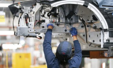 Wholesale price growth cooled off significantly in December. An employee works on a car on the assembly line at the BMW Spartanburg plant in Greer