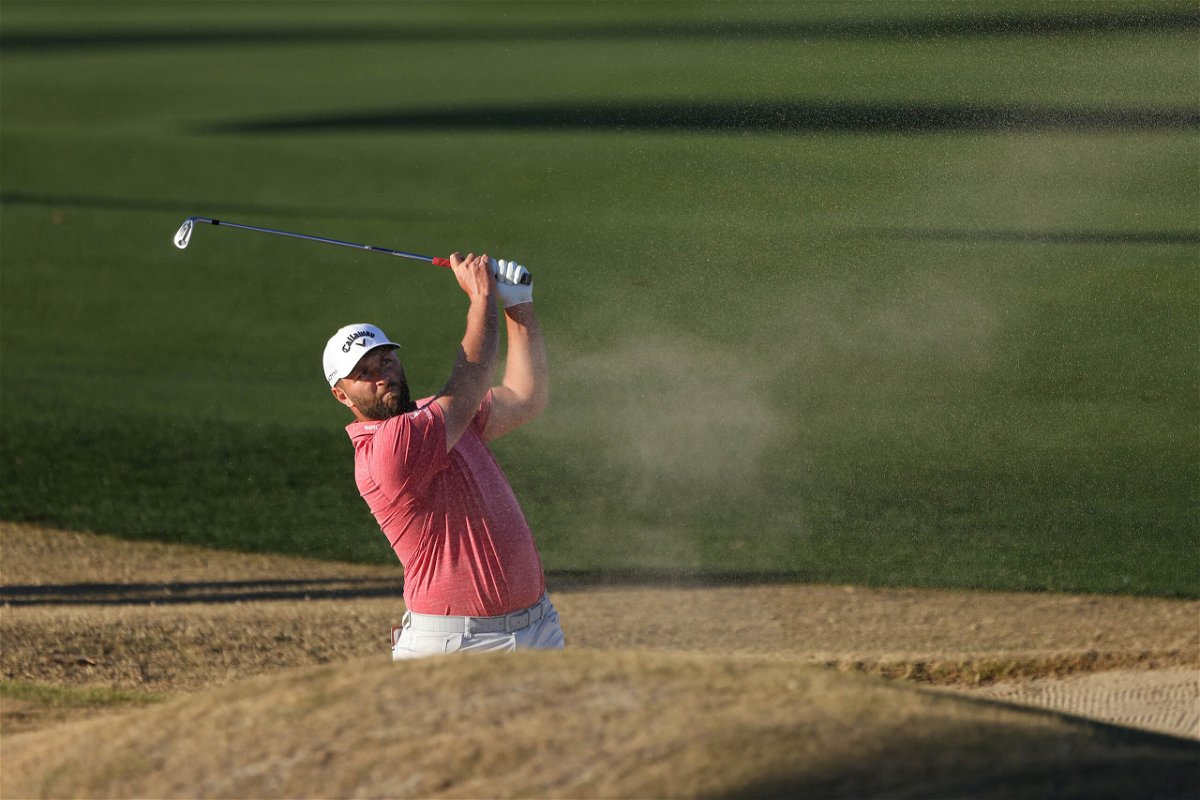 <i>Katelyn Mulcahy/Getty Images</i><br/>Rahm plays a shot from the bunker on the 18th hole.