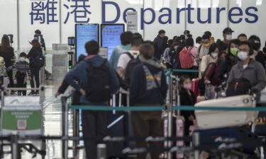 Australia's top health adviser urged the government against restrictions on travelers from China. Pictured are travelers at the Hong Kong International Airport on December 20