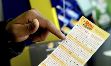 The Mega Millions jackpot has reached an estimated $1.35 billion -- the second-largest in the lottery's history. A Mega Millions lottery slip is displayed at a store in Chicago Tuesday.