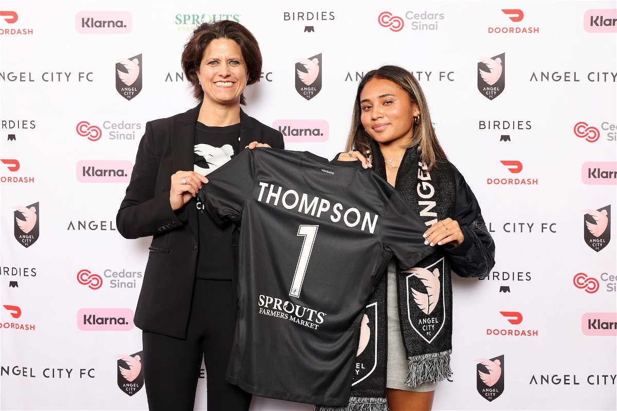 <i>Katelyn Mulcahy/Getty Images</i><br/>Angel City Football Club President Julie Uhrman and first overall draft pick Alyssa Thompson pose with a jersey during the Angel City Draft Party.