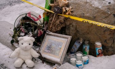 Mourners leave a makeshift memorial outside the scene of the killings on January 3.
