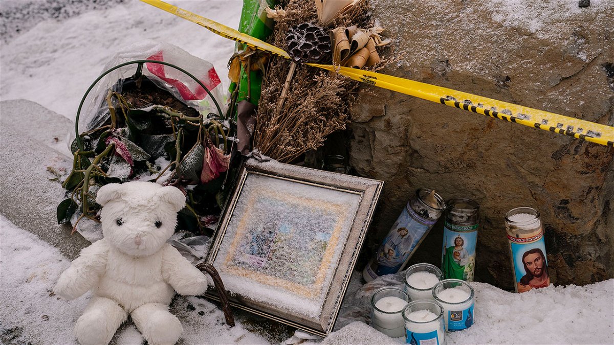 Mourners leave a makeshift memorial outside the scene of the killings on January 3.