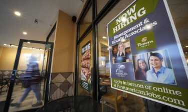 A hiring sign is displayed in the window of a Panera Bread store in Pittsburgh on Monday