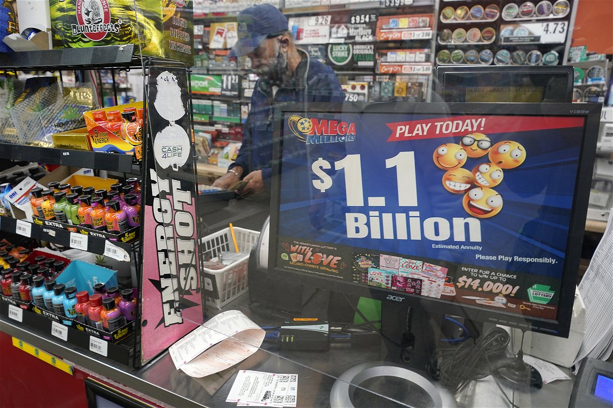 <i>Gene J. Puskar/AP</i><br/>A convenience store in Pittsburgh advertises Tuesday's rare Mega Millions prize exceeding $1 billion.
